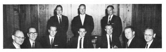 An ADI board meeting from the early 1960s. In the seated row, Bob Howe is in the middle with Jerry Kennedy to his left and Larry Fogerty and Bill Wood on his right. Ed and Elmer Gilbert are seated on the far left and far right.